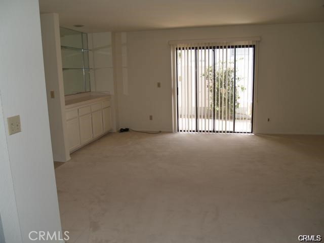 The Family room has a wetbar, fireplace and sliding glass door that leads to a private patio.