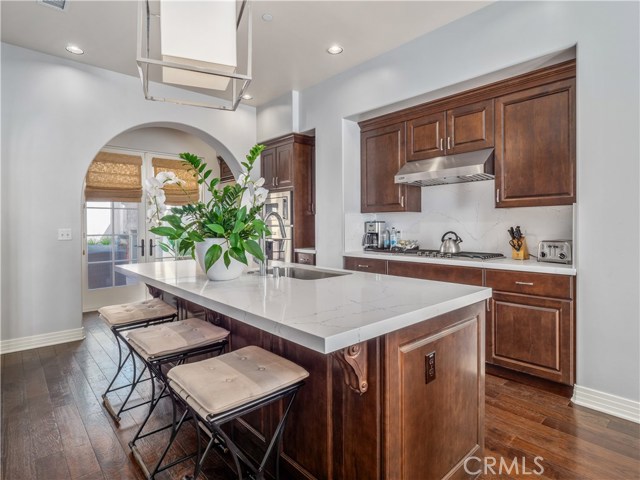 The oversize kitchen island with Quartz countertops is perfect for congregating over breakfast or cocktails.