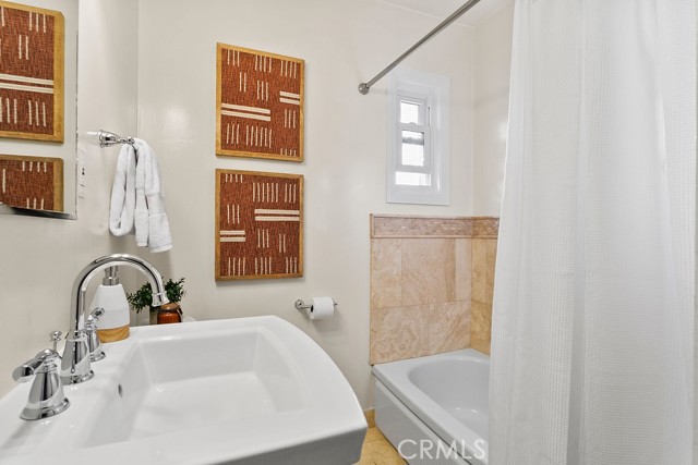 Second bathroom features dedicated bathtub and separate shower (not shown in photo)