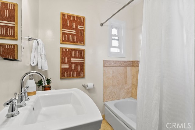 Second bathroom features dedicated bathtub and separate shower (not shown in photo)