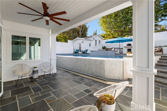 Covered Patio Seating Leads to Designer Styled Infinity Pool