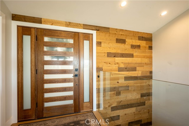 Entry way looking to lower level. Reclaimed wood wall that frames entryway