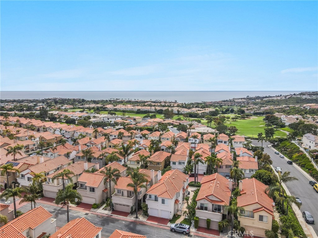 Experience coastal luxury in this stunning guard-gated Monarch Beach home, offering breathtaking ocean, Catalina Island, and sunset views. This turn-key, single-family residence features 3 bedrooms, 2.5 baths, and an open-concept layout designed for comfort and elegance. Upon entering, you’re welcomed by a bright and spacious living room with soaring two-story vaulted ceilings, large windows, upgraded lighting, and a gas fireplace—creating a perfect retreat. Adjacent to the living room, the formal dining area boasts a designer accent wall, adding a touch of sophistication.
The gourmet kitchen features an eat-in breakfast area with ocean views, granite countertops, recessed lighting, and high-end appliances. A large sliding glass door seamlessly connects to the beautifully landscaped backyard, where you’ll find a custom-built stone granite bar, stainless steel gas BBQ, and an in-ground spa—all perfectly positioned to take in the panoramic coastal scenery.  Upstairs, the primary suite is a true sanctuary with wall-to-wall ocean views, a private balcony, and a remodeled ensuite bath featuring dual vanity sinks with granite countertops and a deluxe soaking tub, a lavish walk-in shower, and an oversized closet.  A versatile loft space overlooks the living area, perfect for a home office or additional lounge space. Two generously sized secondary bedrooms offer ample closet space and share access to a spacious front balcony. A beautifully updated full bath with stone flooring and a luxurious standing shower completes the upper level. Located just minutes from the Waldorf Astoria, Ritz Carlton, Dana Point Harbor, fine dining, entertainment, pristine beaches, this home offers an exceptional lifestyle.