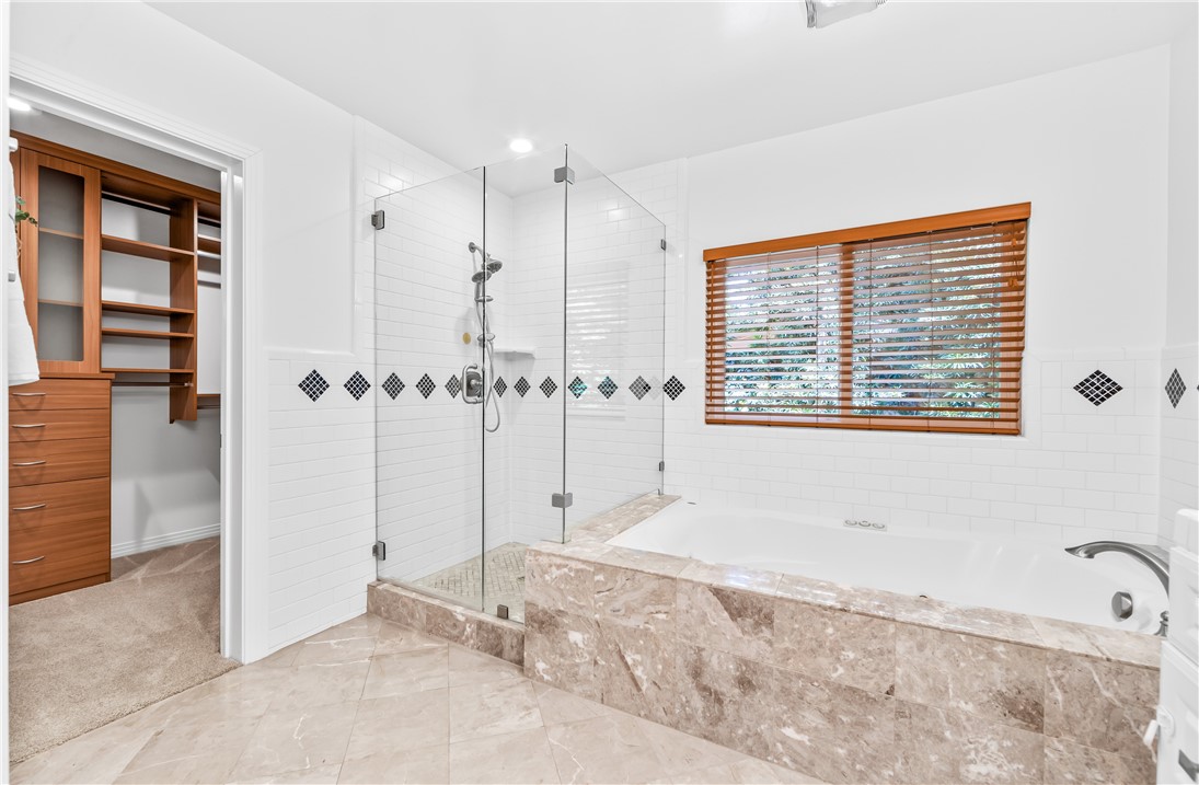 jetted tub and separate shower. Large Custom walk in closet off Primary suit