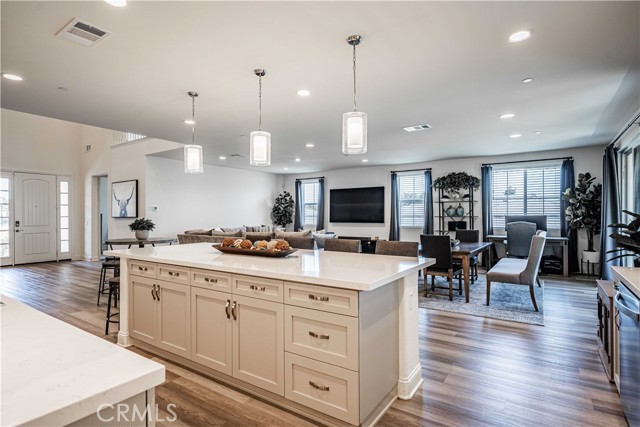 This model home is breathtaking! The 10 foot quartz island has smart plugs built in to charge your phone. The kitchen space opens up to the cozy family room side with tons of windows with views galore!Recessed lighting and natural lighting flood the space!