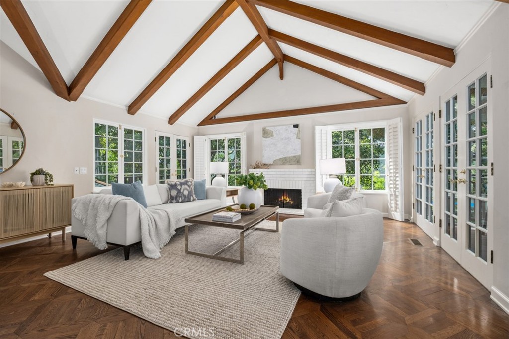 Located in the coveted "Tree Streets" neighborhood of North Laguna; Known for it’s peaceful, small-town feel, where no two homes are alike.  Quality craftsmanship, charm and warmth define this custom Laguna Beach estate.   Situated at the end of a private drive, shared by only three homes, this home is rich with privacy.  Soaring cathedral ceilings, timeless design and quality materials can be seen and felt throughout.  The spacious living, family and dining areas are light, airy and bright with solid wood flooring, custom window coverings and millwork throughout.   Upstairs, the Primary Suite is simply stunning: perched above the treetops, with nice ocean views, privacy and sea breezes for daily enjoyment both indoors and out, on the private master lanai.  Built with California al fresco living in mind, the transition from indoors to outdoors is natural from all areas of the home.  Perfect for multi-generational living, guest accommodations, or creative dual-living arrangements, the residence features a versatile floor plan across multiple levels, enhanced by multiple separate patios and outdoor decks to choose from.   This home is a very short distance from the best beaches, oceanfront Heisler Park, trailheads to Laguna Coast Wilderness Park, and all the wonderful restaurants and galleries that make Laguna Beach a world famous destination.
