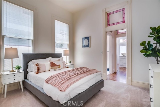 Downstairs bedroom adjacent to half bath and laundry area.