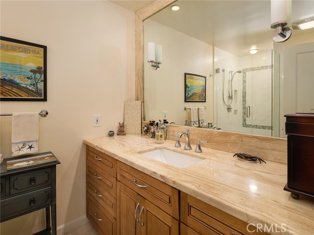 Hall bath with gorgeous stone counter and quality cabinetry.