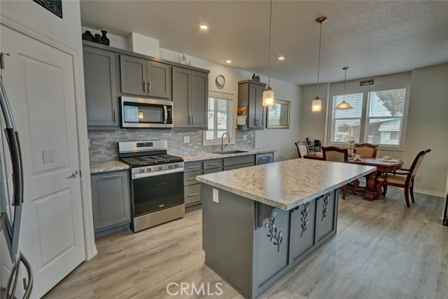 FEATURES A WALK-IN PANTRY, OPEN TO THE LIVING AND DINING