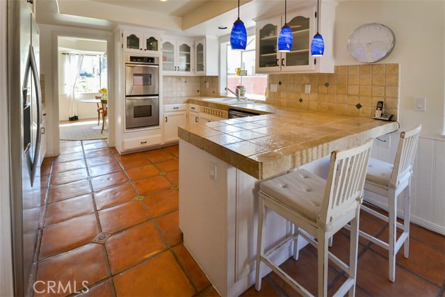 View of the kitchen dining bar and the entry to the formal dining room.