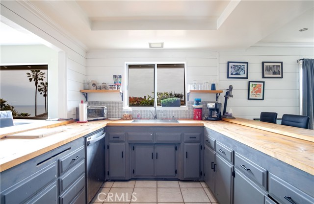 The kitchen has a few windows with ocean view