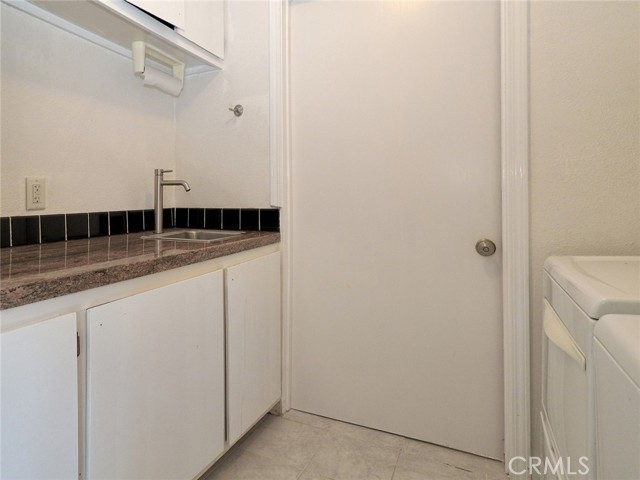 Utility Sink, above and below storage cabinets