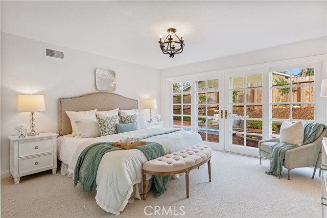 Main bedroom with all wall sliding french doors to the side patio