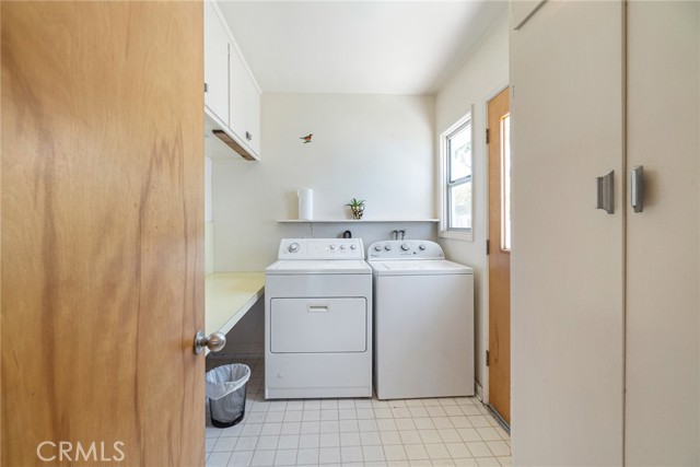 Large, separate laundry room with side door entrance and plenty of storage room