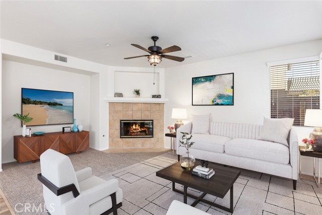 An inviting family room with a fireplace and ceiling fan