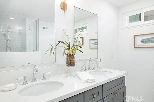 Updated master bathroom with walk-in shower and dual sink vanity.