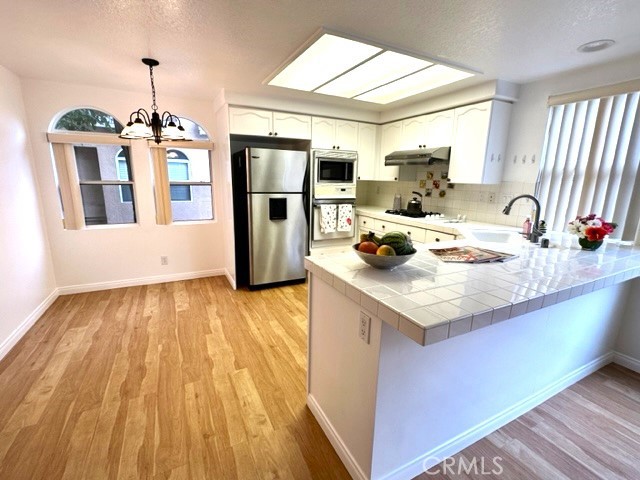 Large gourmet kitchen with lots of cabinets and a counter height breakfast bar.