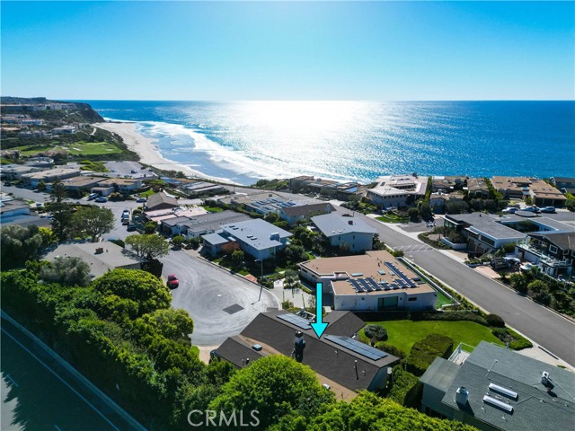 Discover the allure of coastal living in the exclusive, guard-gated enclave of Monarch Bay. Designed for both relaxation and entertainment, this property takes full advantage of its prime location, with an expansive ocean view terrace which has both covered and uncovered seating ideal for basking in the sun and enjoying the sea breeze. This alfresco space feels like an extension of the home flowing meticulously into the great room which provides both a sense of calm and luxury thanks to the soaring ceiling, open living plan and the quality of materials including warm wood floors, stone accents, and a palette of neutral seaside colors. The orientation of the great room naturally provides spectacular light. Both ocean and headlands view completes the room's natural beauty.  The primary suite with its ocean view, balcony, two large walk-in closets and zen-inspired bathroom is separate from the other bedrooms situated downstairs with their accompanying living room, private patio and outdoor spa. The property features include a smart home system, security cameras, solar panels, exterior privacy blinds and LED lighting. Additionally a three-car garage, spacious driveway parking and landscaped privacy space on both sides of the home. 
The proximity to the sea is both restorative and invigorating. There is tennis, pickleball, bocce ball and of course swimming and surfing. The private on--the-sand beach club offers an indoor-outdoor bar, sunset fine dining and a beachside lunch. Butler service provides chairs, towels and umbrellas. In addition, there are firepits, indoor/outdoor gathering areas and community events and celebrations.  Experience the resort lifestyle in Monarch Bay in this prestigious community.  Its quintessential placement along the California Riviera makes it ideal to enjoy Laguna Beach, Dana Point Harbor, golf, seaside hiking trails and five-star resorts including the Ritz-Carlton, Waldorf Astoria and the Montage.