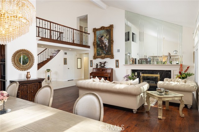 Inside, a grand foyer with a wrought-iron adorned spiral staircase welcomes you.