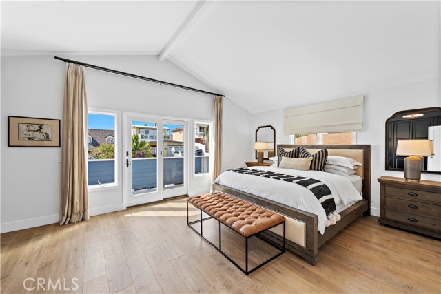 Primary Bedroom features a California King Bed and balcony with peek a boo ocean views.
