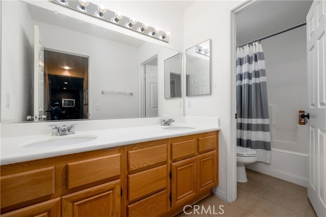 Secondary bathroom with double sink vanity.