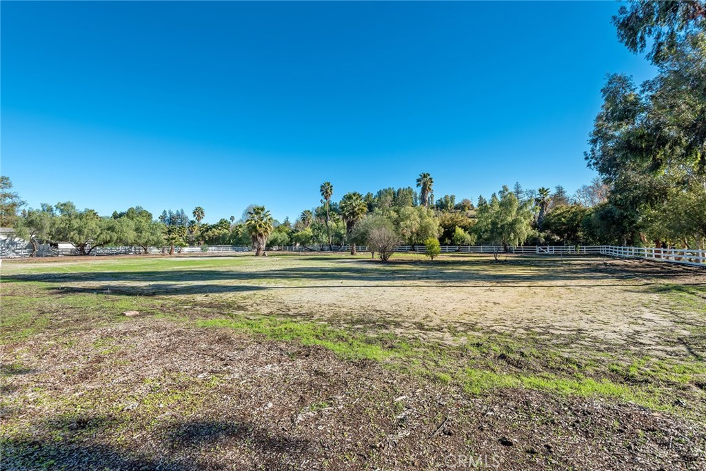 This spectacular 2.5 acre, huge flat lot is nestled at the very end of a quiet cul-de-sac. It offers room to build your dream estate with every amenity on parklike grounds. This is one of the very largest, flat lots in all of Hidden Hills. Soils report and survey are available. The property is sold AS-IS for land value only.