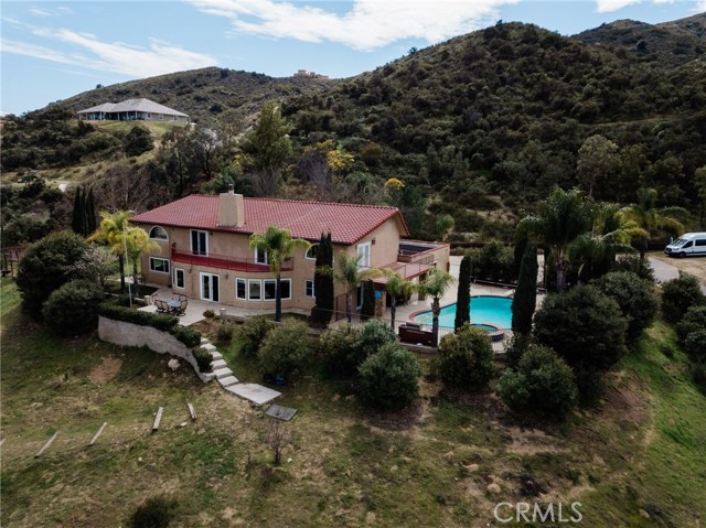 22053 Highland Street Wildomar, California Majestic 4,300 sq-ft horse property with swimming pool on 4 acres . This beautiful home has breathtaking views from all around the property. Welcome all your guests at picturesque grand entry . Home has 5 bedrooms , 3.5 baths plus office and loft. Large Kitchen with high quality granite counter tops with counter bar, huge island, and custom made cabinets. Home comes with stainless steel oven,stove ,and dishwashers .Home offers tall cathedral ceilings, upstairs laundry for convenience, office space upstairs and downstairs. It has one room downstairs and 4 bedrooms upstairs, 3 bedrooms with balcony . Home has large windows though out the home to allow much natural light to enter and to capture natural scenery. Custom made stairs, railings and banisters in wood and iron. The huge lot offers horse stables and riding space below, basketball court , volleyball court , swimming pool and spa. Great home for entertaining family parties or large events .Desirable neighborhood has many trails for riding , hiking and it is very quiet and peaceful. Near fwy shopping , and award wining schools.