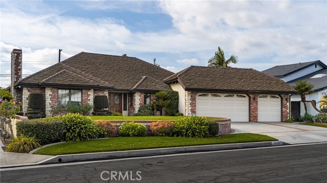 Charming Brick Exterior with Beautiful Landscaping and Three-Car Garage