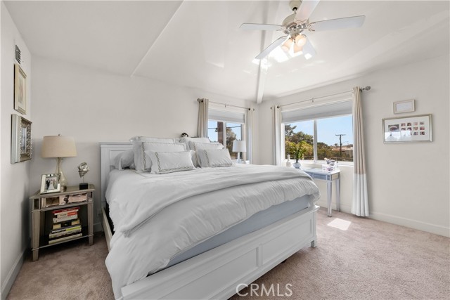 Primary Bedroom with Vaulted ceiling and fan