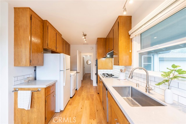 Galley kitchen with European style, in kitchen washer and dryer.