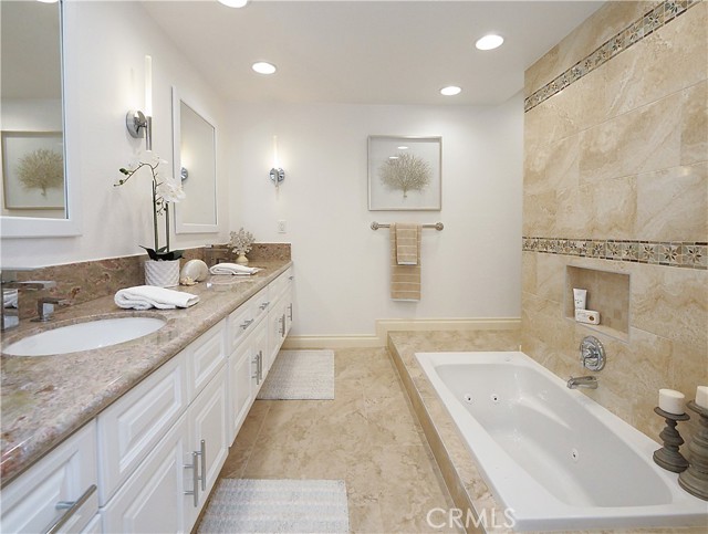 Tastefully remodeled primary bathroom with a jacuzzi tub