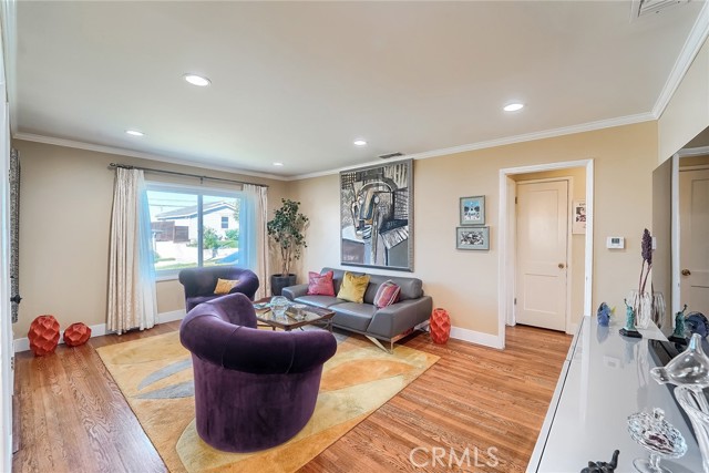 Living room features recessed lighting & crown molding.