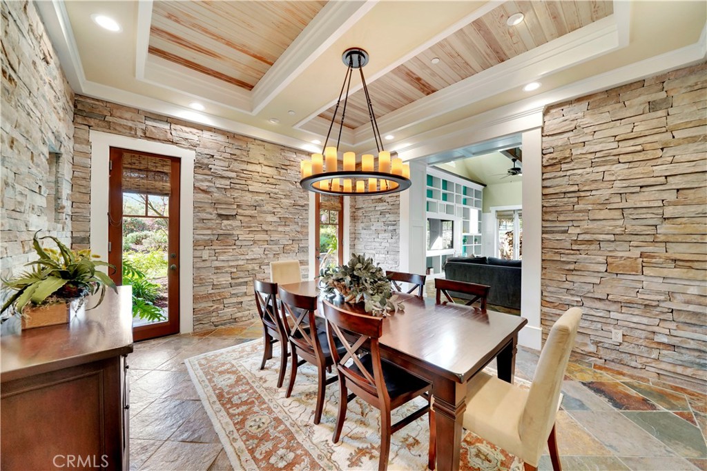 another view of dining room note door to front patio and custom chandelier
