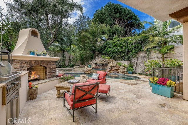 848 11th Street Manhattan Beach, California Spanish-inspired high quality custom home in the desirable Hill Section. Arched, 8’ leaded glass front door opens to high ceilings and an eye-catching stone fireplace. Soak in the sunny, south facing backyard through dual sets of French doors. Slide the pocket doors closed and enjoy dinner in the formal dining room, adjacent to the kitchen and great room which features an oversized fireplace. Gourmet Kitchen w/ stainless appliances, center island, granite countertops and breakfast nook. Enjoy staycations in the professionally designed backyard with built-in bbq, fireplace, grassy area, grotto style pool & spa with imported Tennessee stone accents. Waterfalls create a soothing sound as you relax in this private oasis. Master suite w/ walk-in closet with custom built-ins, spa-like bathroom, jetted tub, steam shower, & balcony overlooking the back yard. Open hallway that overlooks the formal living room and stately fireplace wall feature. Dual staircases offer two-way access to the top floor. Spacious basement with natural light perfect as a home theater, game room, workout room, and adjoining (optional 6th bed) guest room with full bath. Features: 8’ doorways with solid wood doors, hardwood floors throughout, custom window treatments, a water filter/water softener system & more. Generous counter space and a sink in the laundry room. Attached 3-car immaculate garage equipped with an abundance of built in storage, work table, (2) 50 amp auto charging stations.