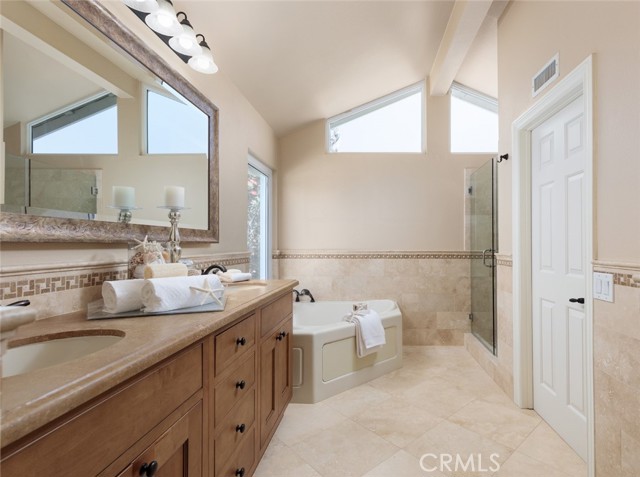 Remodeled Luxury Primary Bathroom with Soaking Tub, Separate Shower and His and Hers Walk-In Closets