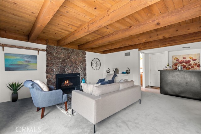 Here we have your Family room with Gas fireplace and Wet bar. Notice the entry access to your 3 car garage left to wet bar.   And your powder room to the left of garage door.