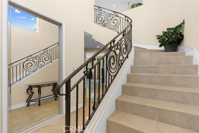 Travertine floors and winding staircase to the living area.