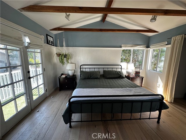 French doors opening to a peaceful tree lined view, windows galore... you will not want to come downstairs at all!