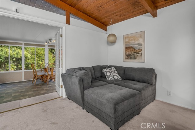 View #2 of the second bedroom with easy access to the sun porch with a view of the large bak yard