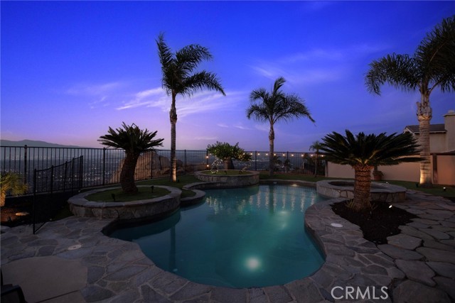 Twighlight view of pebble tec pool and spa