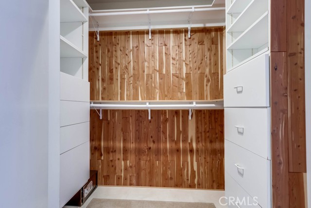 Primary bedroom closet, behind mirror