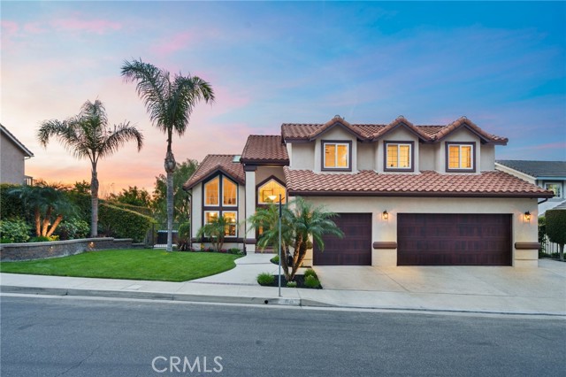 Stunning Anaheim Hills Home with Panoramic Views! Nestled in the heart of Anaheim Hills on a peaceful cul-de-sac, 8085 E Kendra Ct offers breathtaking city light and snow-capped mountain views. This beautifully upgraded 4-bedroom, 2.5-bath home spans approximately 2,200 sq. ft. and features a 3-car garage with epoxy floors and built-in cabinetry. Step inside to find elegant wood flooring and an upgraded iron staircase, setting the tone for this sophisticated residence. To the right, the inviting family room boasts a cozy fireplace, Bowers & Wilkins surround sound system, and a sliding glass door that leads to the backyard—offering an incredible indoor-outdoor living experience. Electronic equipment is neatly stored in a pullout cabinet for a sleek, clutter-free look. The remodeled kitchen is a chef’s dream, featuring recessed lighting, stainless steel appliances, granite countertops, a stylish tile backsplash, and a reverse osmosis system. A breakfast nook and slider provide easy access to the backyard, perfect for morning coffee with a view. The formal dining room, conveniently adjacent to the kitchen and you have another slider to the backyard. The spacious formal living room adds to the home’s charm.The main floor also includes a remodeled half bath and an inside laundry room for convenience. Upstairs, the luxurious primary suite is a private retreat, complete with a ceiling fan, a sliding door leading to a Trex deck with stunning views, and a walk-in cedar-lined closet. The remodeled primary bath features dual sinks, a carrara marble shower with matching walls, brizo faucets and fixtures and a skylight with dual-pane glass and an automatic shade. The secondary bedrooms offer LVP floors, ceiling fans, cedar-lined closets, and window shutters. The remodeled hall bath features dual sinks and a porous marble shower with matching walls.Exceptional Outdoor Living designed for relaxation and entertaining, the backyard boasts professional landscaping by Seth Pompey, landscape lighting, a built-in BBQ with a fridge, a covered patio extending from the upper deck, and an above-ground spa with an outdoor shower. Additional Features Recently painted exterior, New garage doors & rain gutters. High-energy efficient roof with dual-layer paper, reflective membrane. Whole-home soft water and filtration system, 9 security cameras on the house & 12 on the street This meticulously maintained home offers the perfect blend of comfort, luxury, and breathtaking scenery.