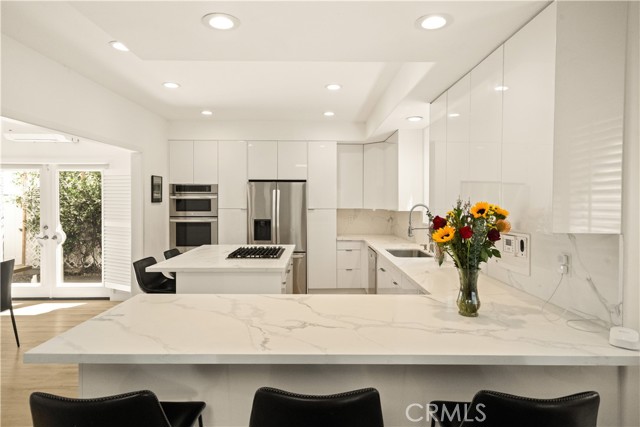 Remodeled 2023 kitchen — open concept, center island, bar seating