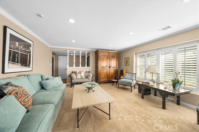 Bright front living room with plantation shutters