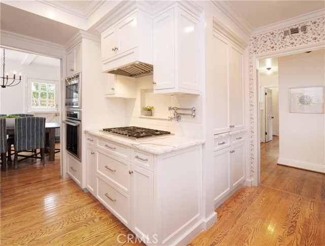 Kitchen view with 6 burner gas cooktop and instant hot water