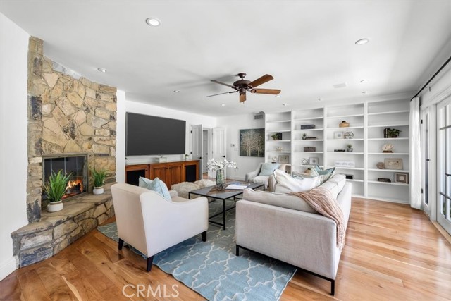 Family Room with Fireplace, Built-in media cabinet, built-in shelves and French Doors leading to the amazing backyard!