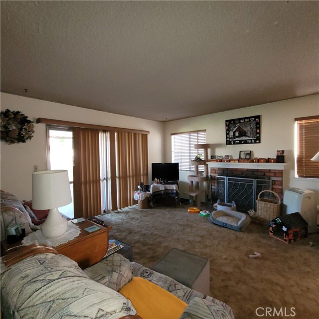 Living room with brick fireplace.