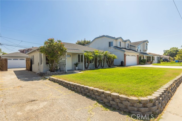 Driveway with gate open leading to two car garage and enough space for additional cars.