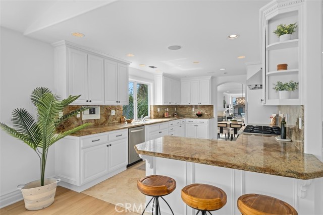 Kitchen with breakfast bar opens to Family room