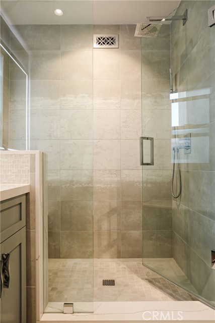 Primary bathroom with large walk in shower and frameless glass enclosure